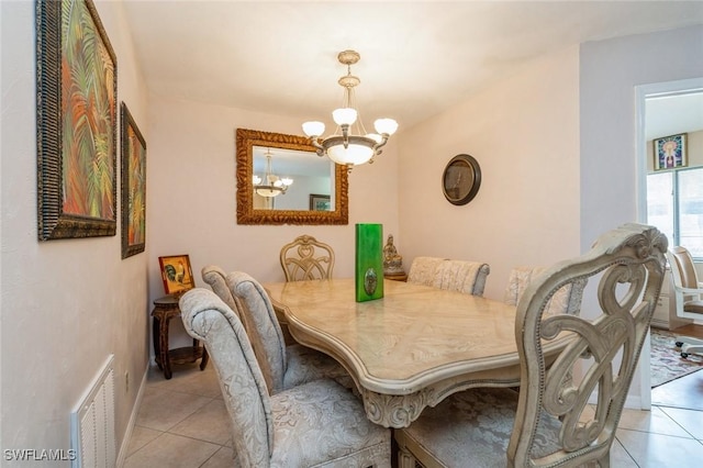 dining area featuring visible vents, an inviting chandelier, and light tile patterned flooring