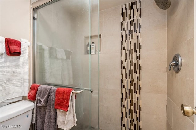 full bath with toilet and a shower stall