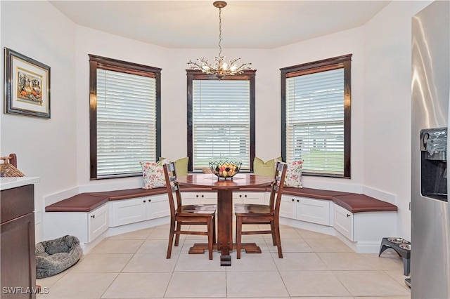 dining area featuring a notable chandelier and light tile patterned floors