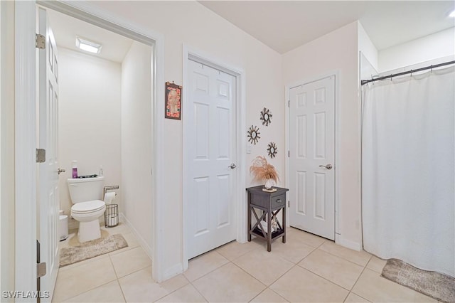 bathroom featuring tile patterned flooring and toilet