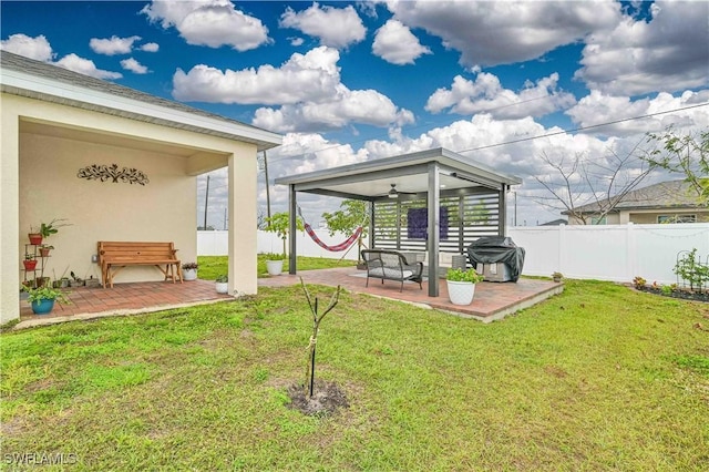 view of yard with a patio and ceiling fan