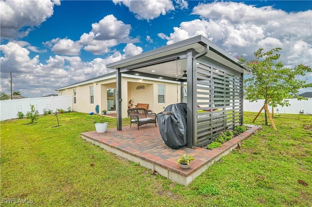 back of house featuring a yard and a patio area