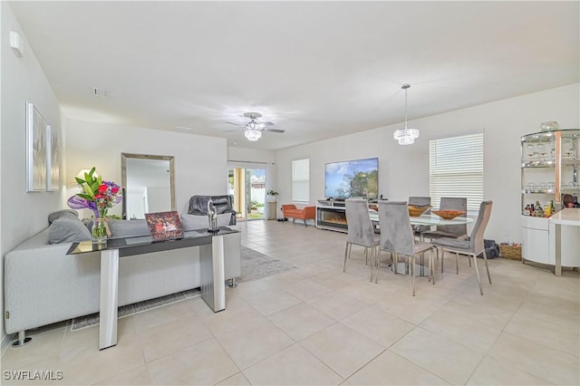 tiled dining area with ceiling fan