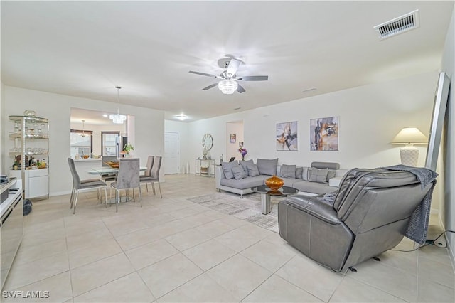 tiled living room featuring ceiling fan