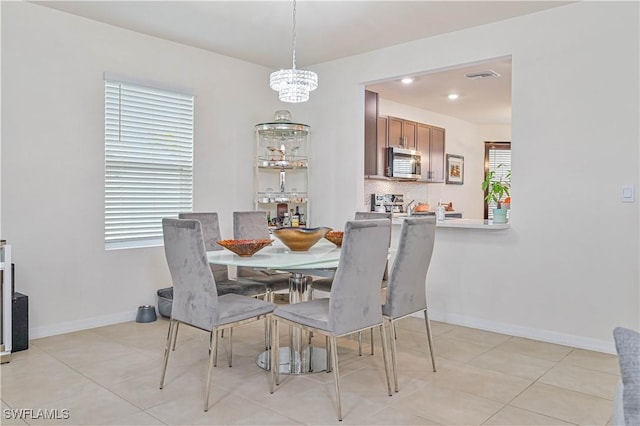 dining space featuring light tile patterned floors