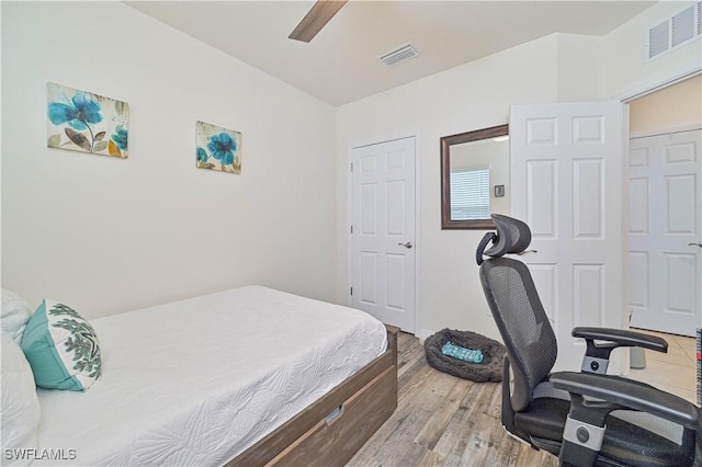 bedroom with a closet, ceiling fan, and light hardwood / wood-style flooring