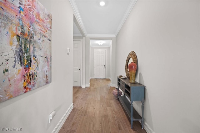 hall with crown molding and light wood-type flooring