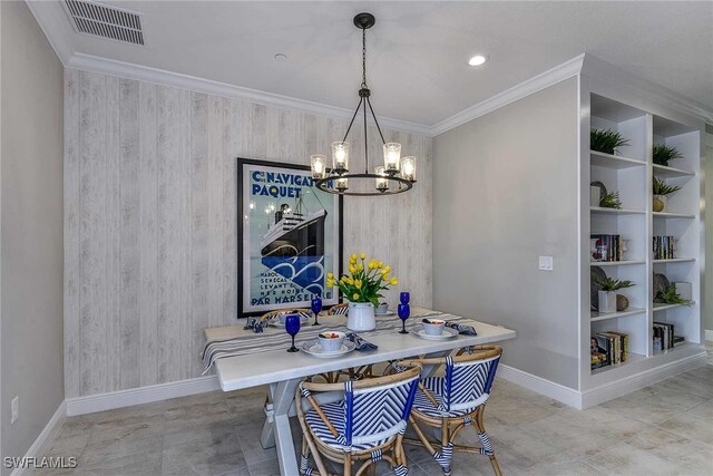 dining area with built in shelves, an inviting chandelier, and ornamental molding