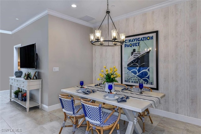 dining area with crown molding, an inviting chandelier, wooden walls, and light tile patterned floors