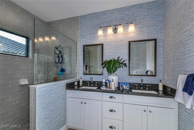 bathroom featuring walk in shower and vanity