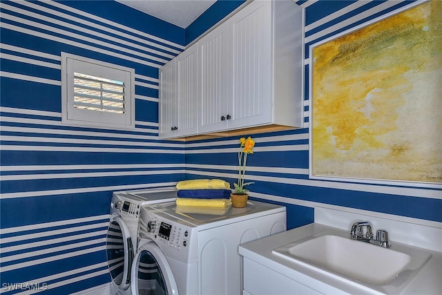 laundry room featuring cabinets, separate washer and dryer, and sink