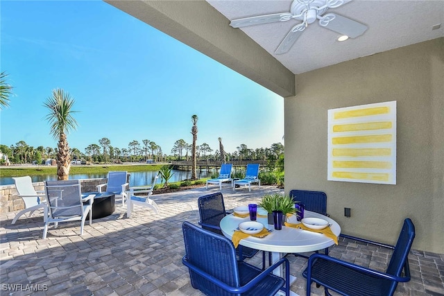 view of patio / terrace featuring a water view and ceiling fan