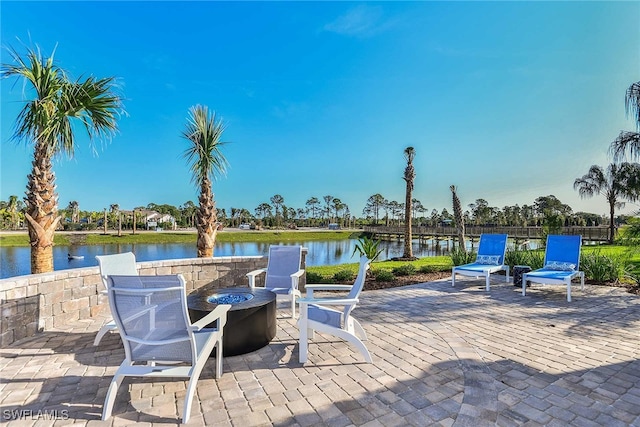 view of patio / terrace with a water view and an outdoor fire pit