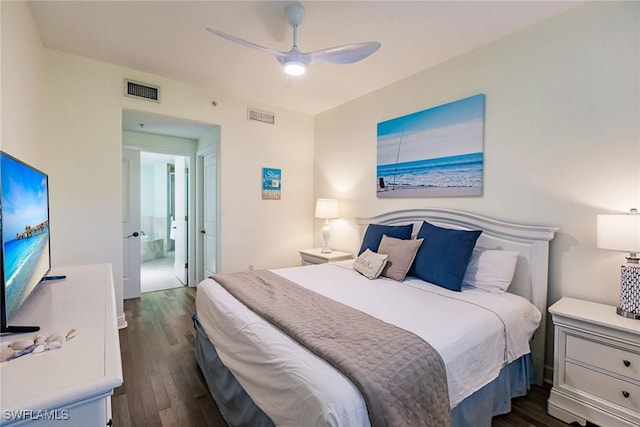 bedroom with ceiling fan, dark hardwood / wood-style flooring, and ensuite bath