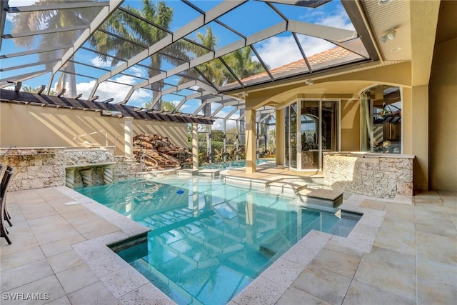 outdoor pool with glass enclosure, an outdoor kitchen, and a patio