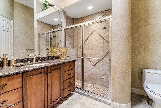 full bath with baseboards, a shower stall, toilet, and vanity