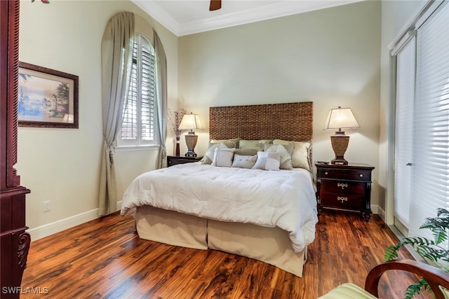 bedroom with baseboards, ceiling fan, wood finished floors, and crown molding