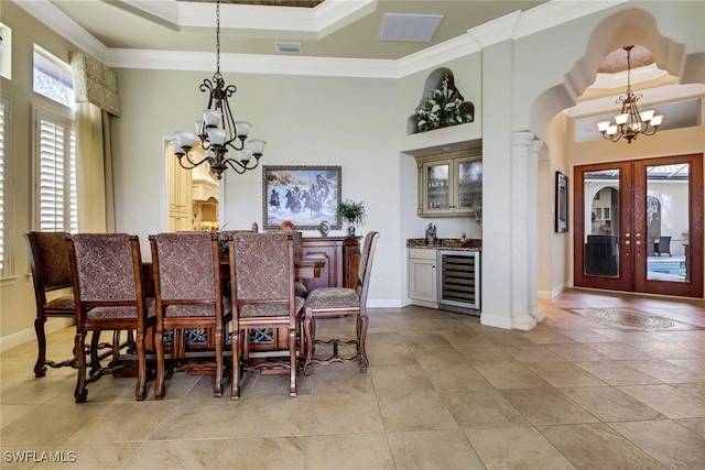 dining room featuring a chandelier, wine cooler, ornamental molding, and visible vents