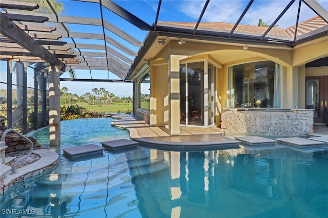 pool featuring glass enclosure and a patio