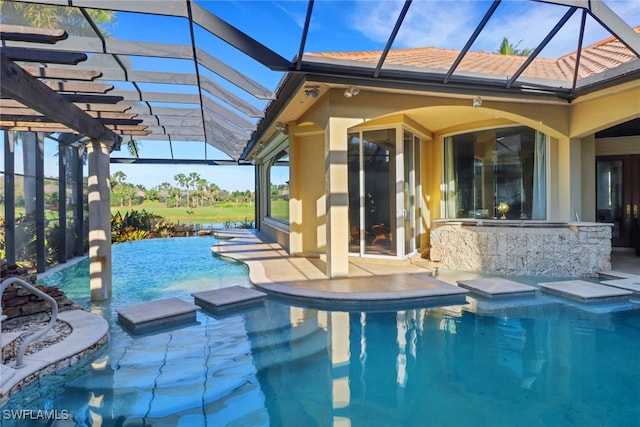 outdoor pool with a lanai and a patio area