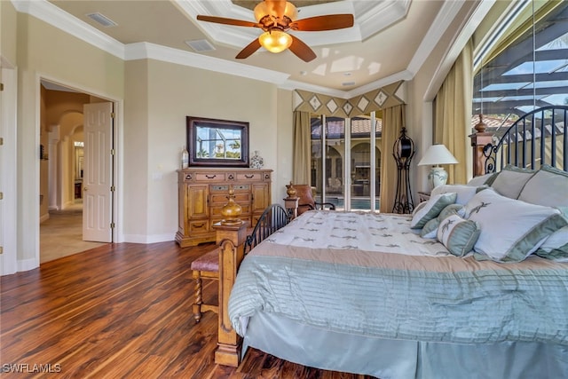 bedroom with visible vents, arched walkways, wood finished floors, and ornamental molding