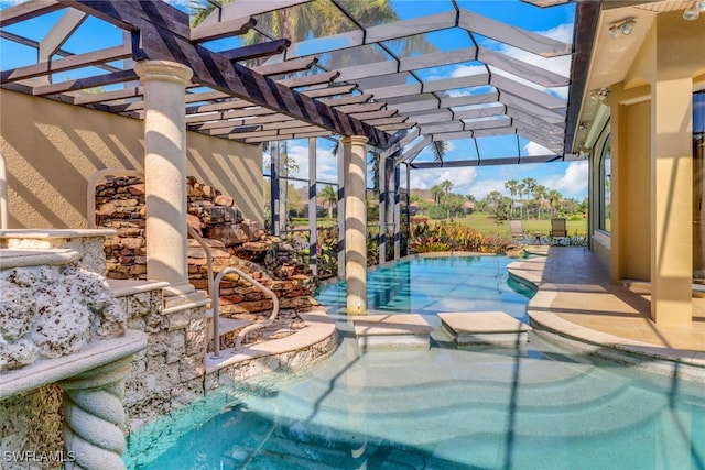 view of swimming pool featuring a patio, a lanai, and a pool with connected hot tub