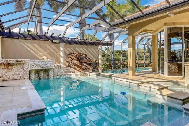 outdoor pool with a lanai, a patio, and an outdoor kitchen