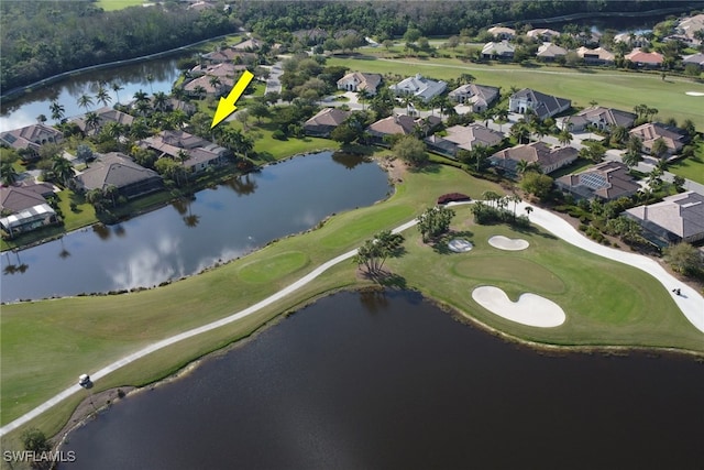 drone / aerial view with a water view, a residential view, and golf course view