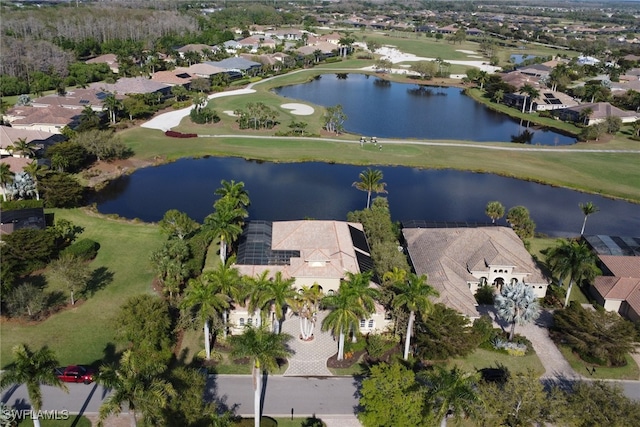 bird's eye view featuring a water view, view of golf course, and a residential view