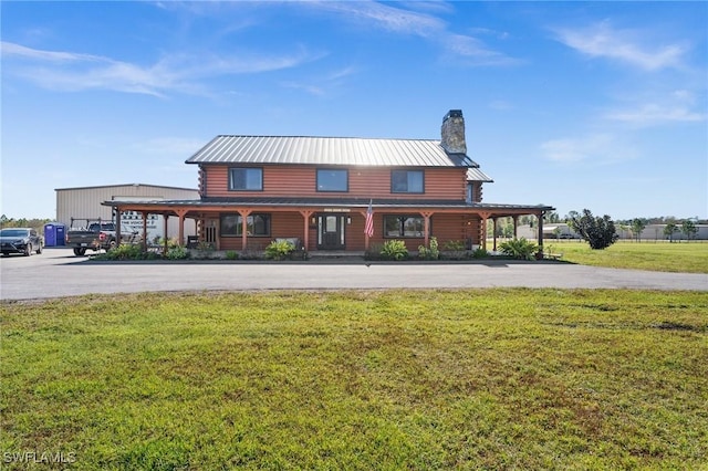 rear view of house with a yard