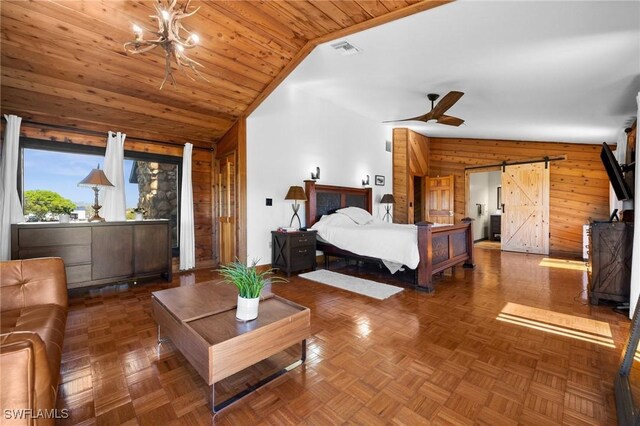 bedroom featuring lofted ceiling, a barn door, dark parquet flooring, and wood walls