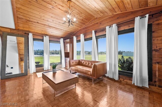 sunroom with vaulted ceiling, a healthy amount of sunlight, wood ceiling, and an inviting chandelier