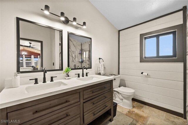 bathroom with vanity, walk in shower, toilet, and wood walls