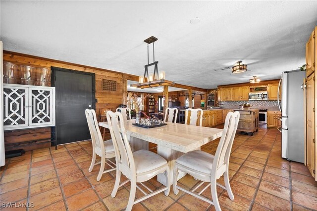 dining space with wooden walls