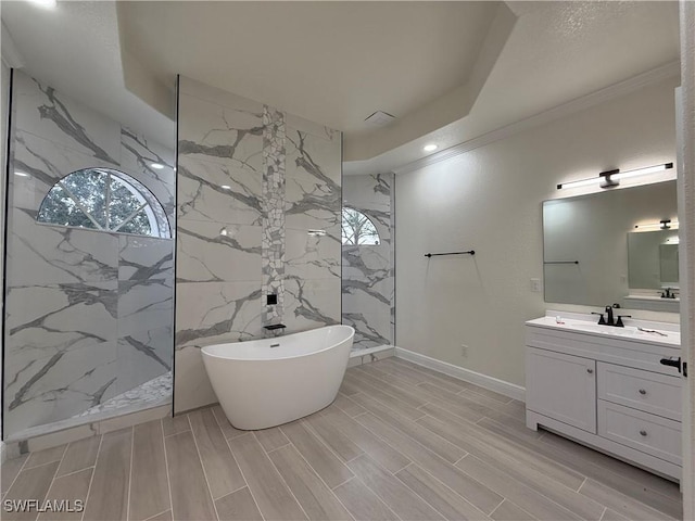 bathroom with crown molding, a raised ceiling, vanity, and shower with separate bathtub