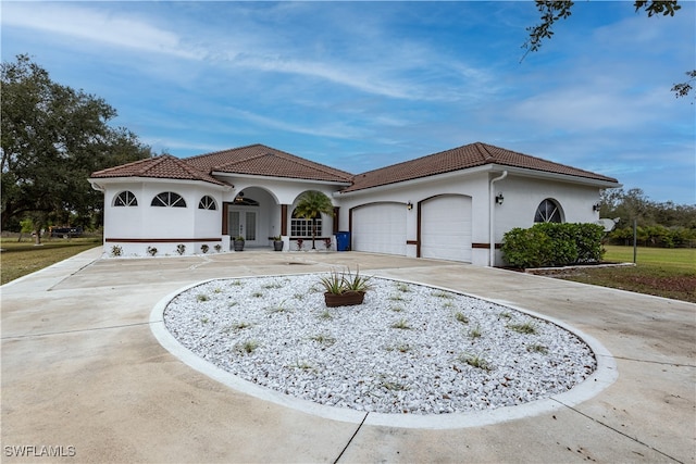 mediterranean / spanish-style home with french doors and a garage