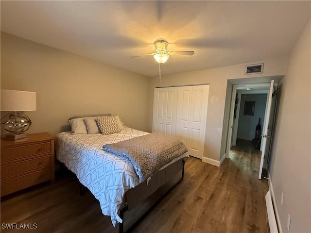 bedroom featuring ceiling fan, dark hardwood / wood-style flooring, and a closet