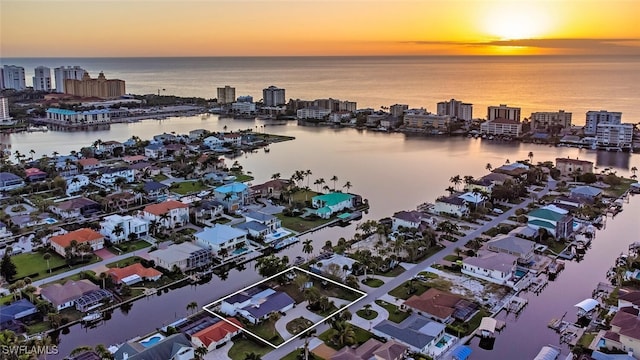 aerial view at dusk with a water view