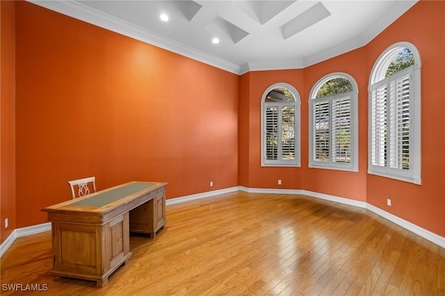 empty room with ornamental molding and light wood-type flooring