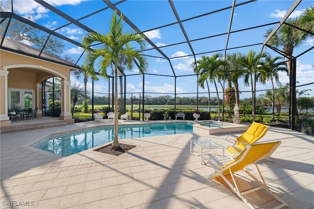 view of pool featuring an in ground hot tub, a patio, and a lanai