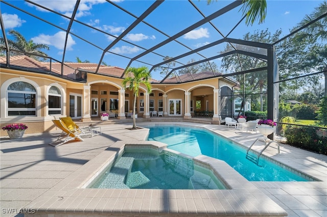 view of pool with an in ground hot tub, a lanai, french doors, ceiling fan, and a patio area