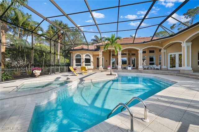 view of swimming pool with an in ground hot tub, a lanai, a patio, french doors, and ceiling fan