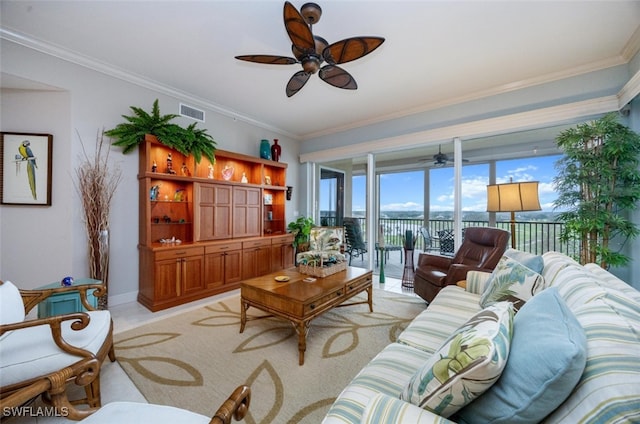 living room featuring ornamental molding, visible vents, ceiling fan, and baseboards