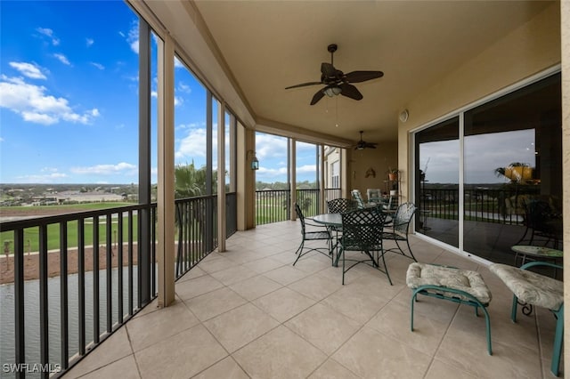 sunroom / solarium with a ceiling fan