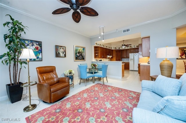 living area with light tile patterned floors, visible vents, ornamental molding, a ceiling fan, and baseboards