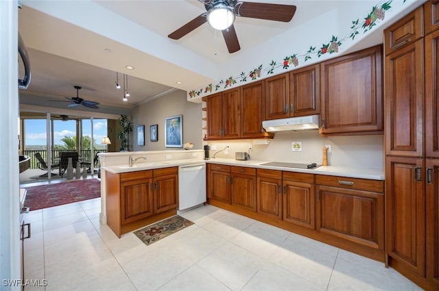 kitchen featuring brown cabinetry, dishwasher, a peninsula, black electric stovetop, and under cabinet range hood