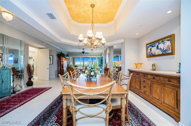 dining room featuring crown molding, a raised ceiling, visible vents, and a notable chandelier