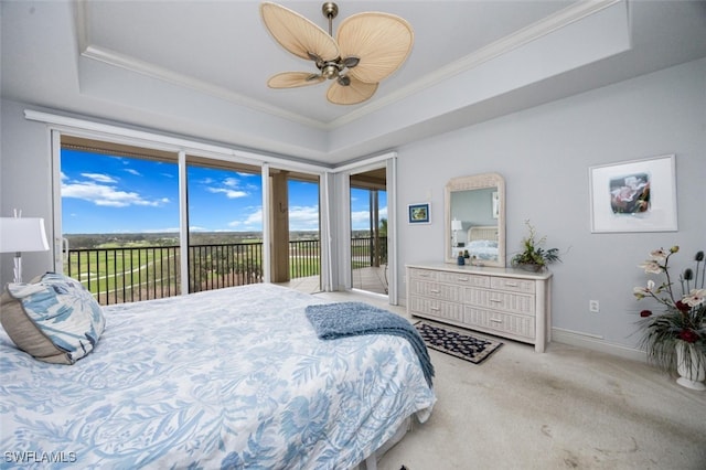 bedroom featuring access to exterior, a tray ceiling, carpet flooring, and ornamental molding