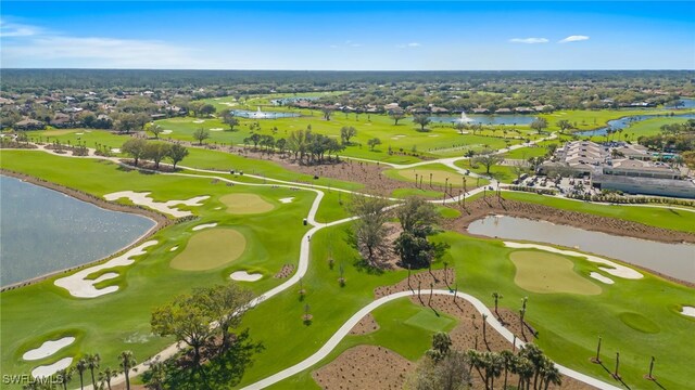 drone / aerial view featuring view of golf course and a water view