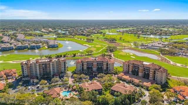 drone / aerial view featuring golf course view and a water view